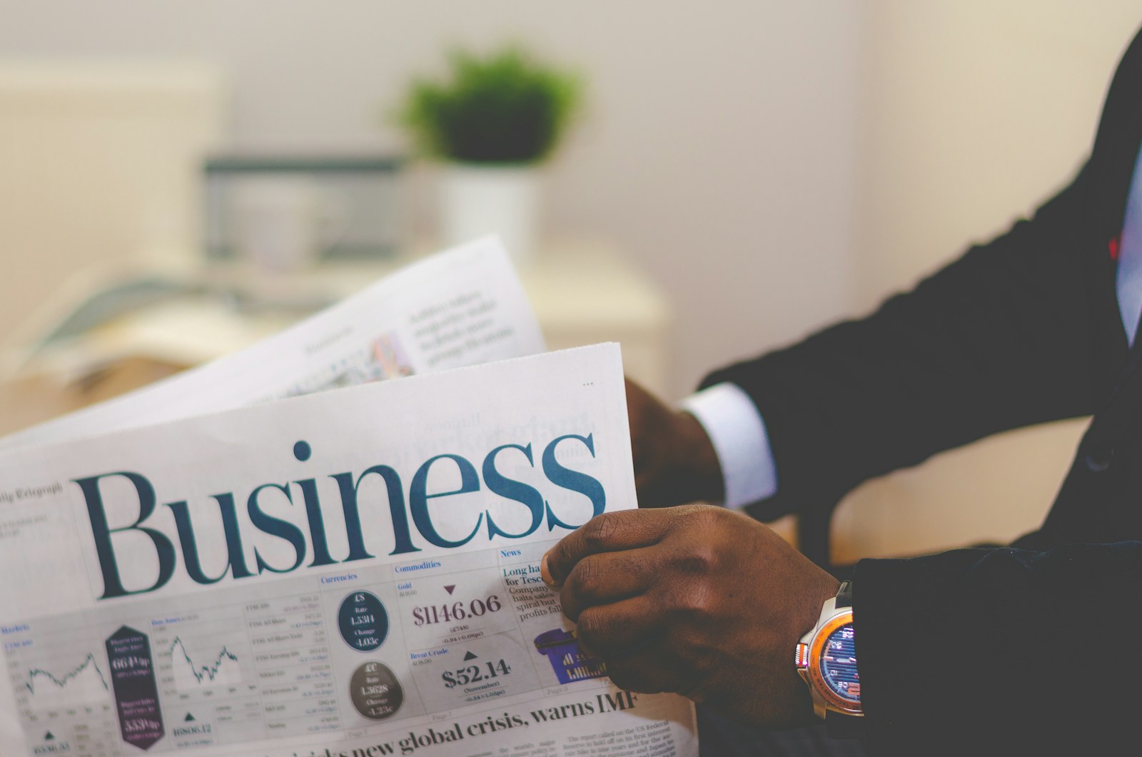A business professional reading financial news
